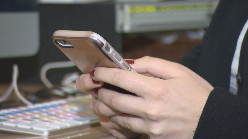 A social media user scrolls through their phone